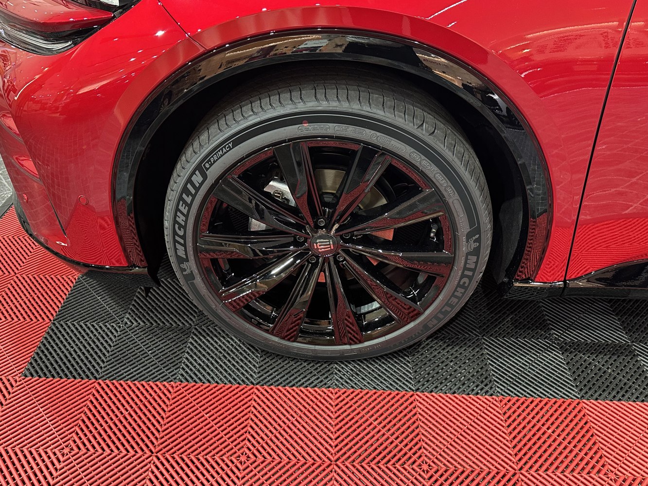 Glossy black multi-spoke alloy wheel with Michelin tire