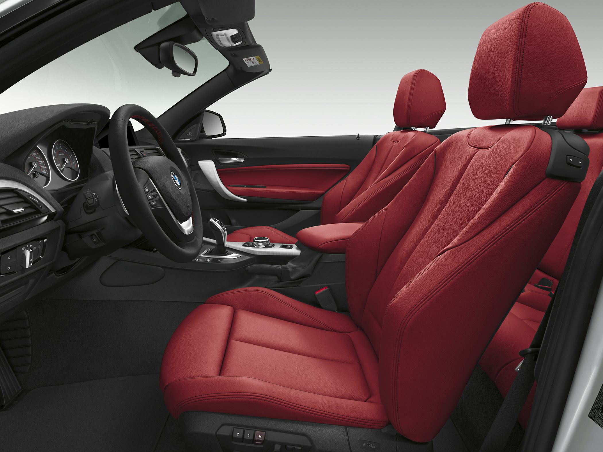 Red leather seats and modern dashboard in convertible interior