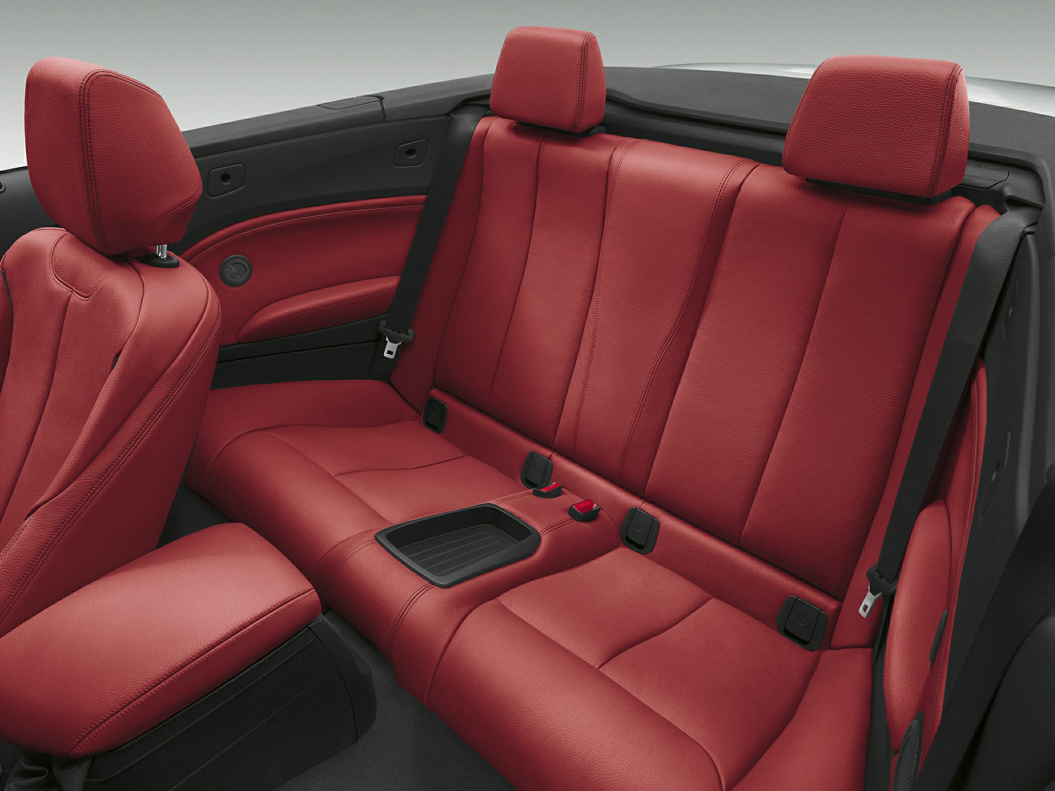Red leather rear seats with headrests and seat belts