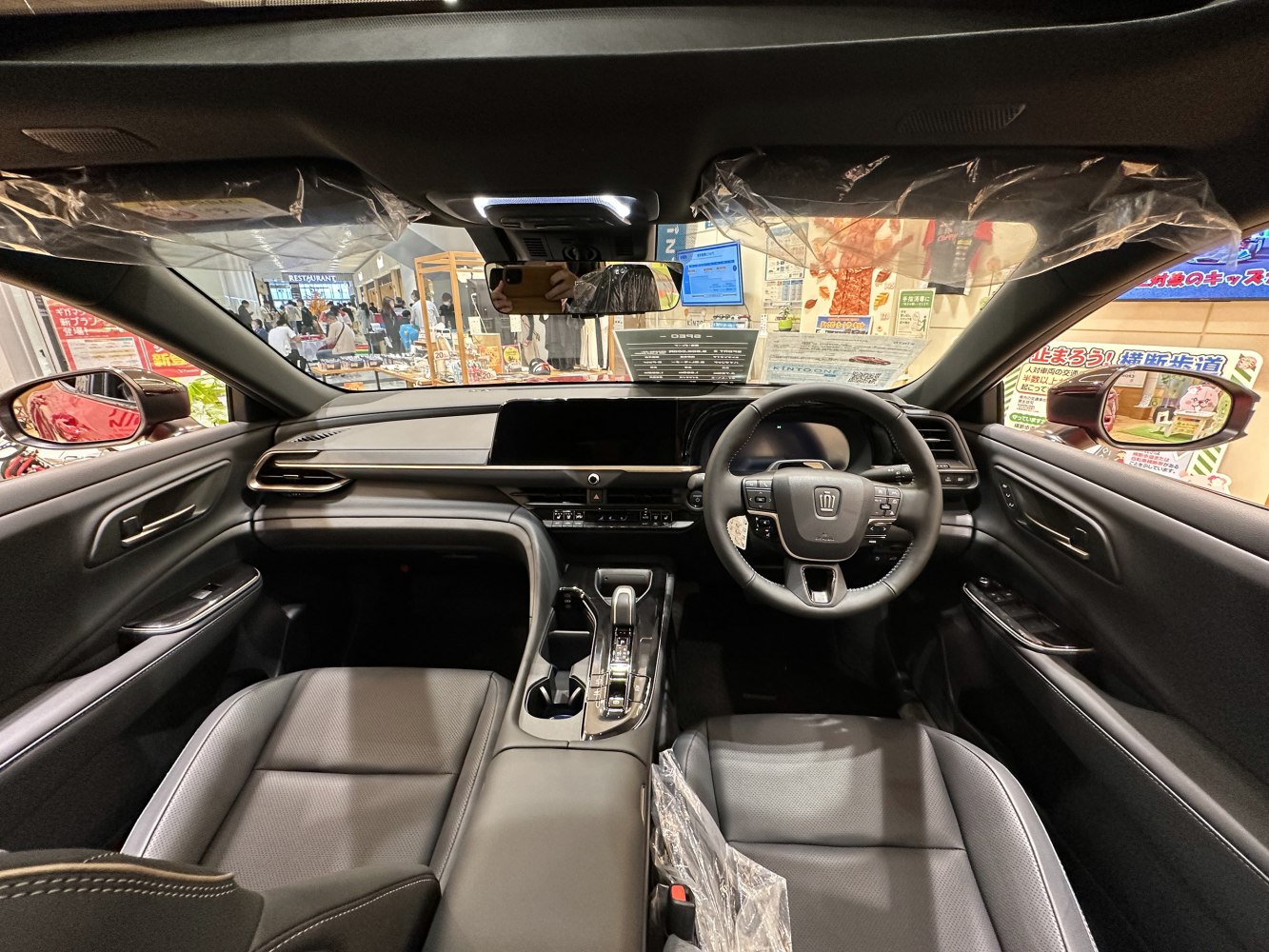 Modern black leather interior with digital dashboard and advanced steering wheel.