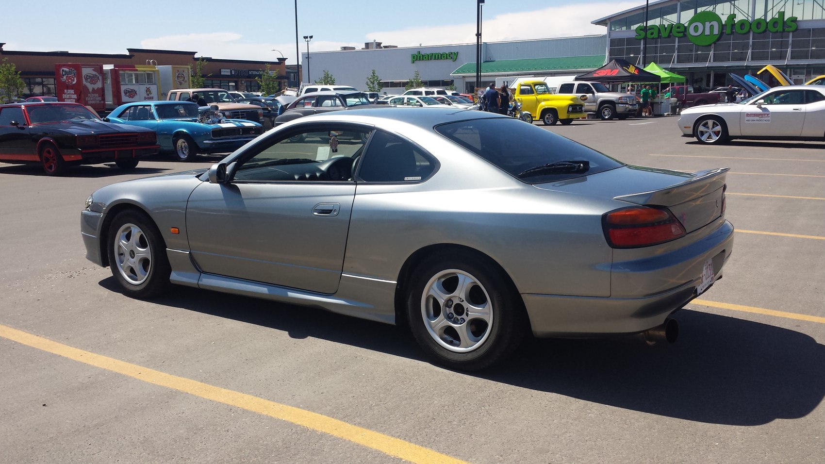 Silver two-door sports coupe with rear spoiler and rounded tail lights