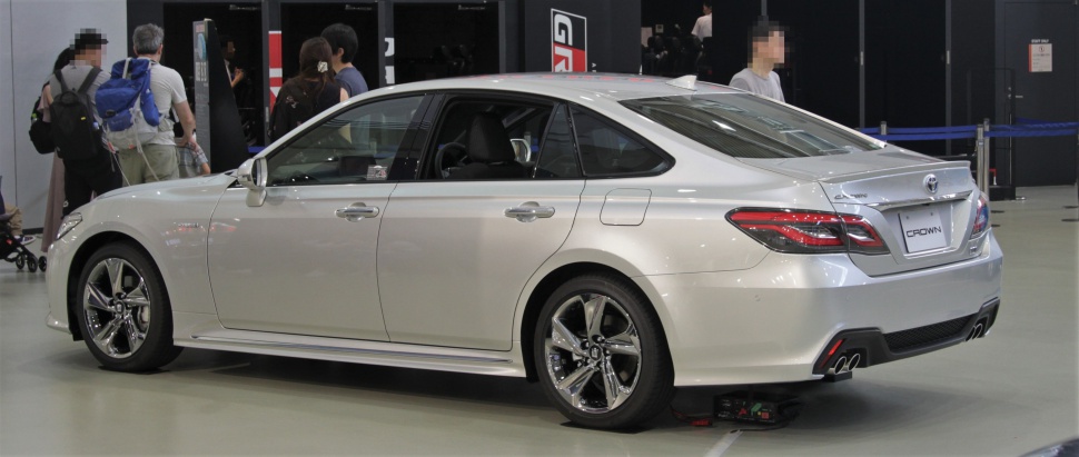 Silver sedan side rear view with quad exhaust and alloy wheels