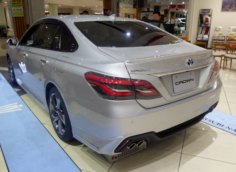 Rear view with stylish taillights and quad exhaust tips on silver sedan