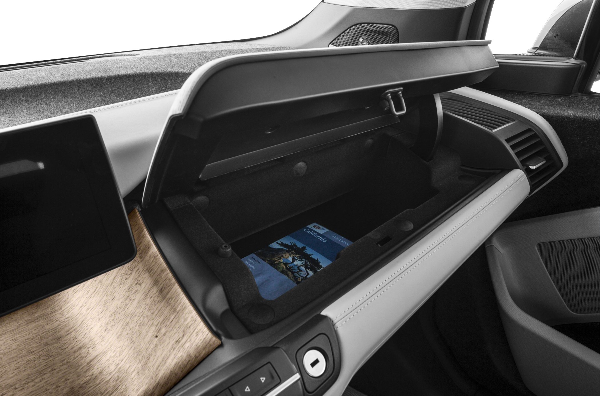 Open glove compartment with black interior and wood trim