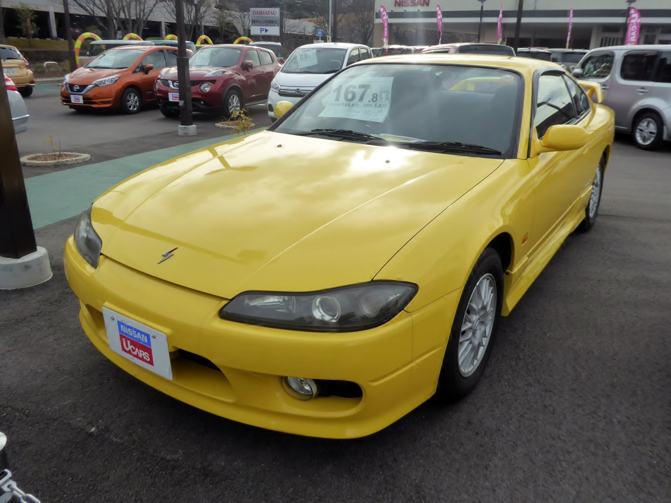 Yellow sports coupe with sleek headlamps and aerodynamic body kit
