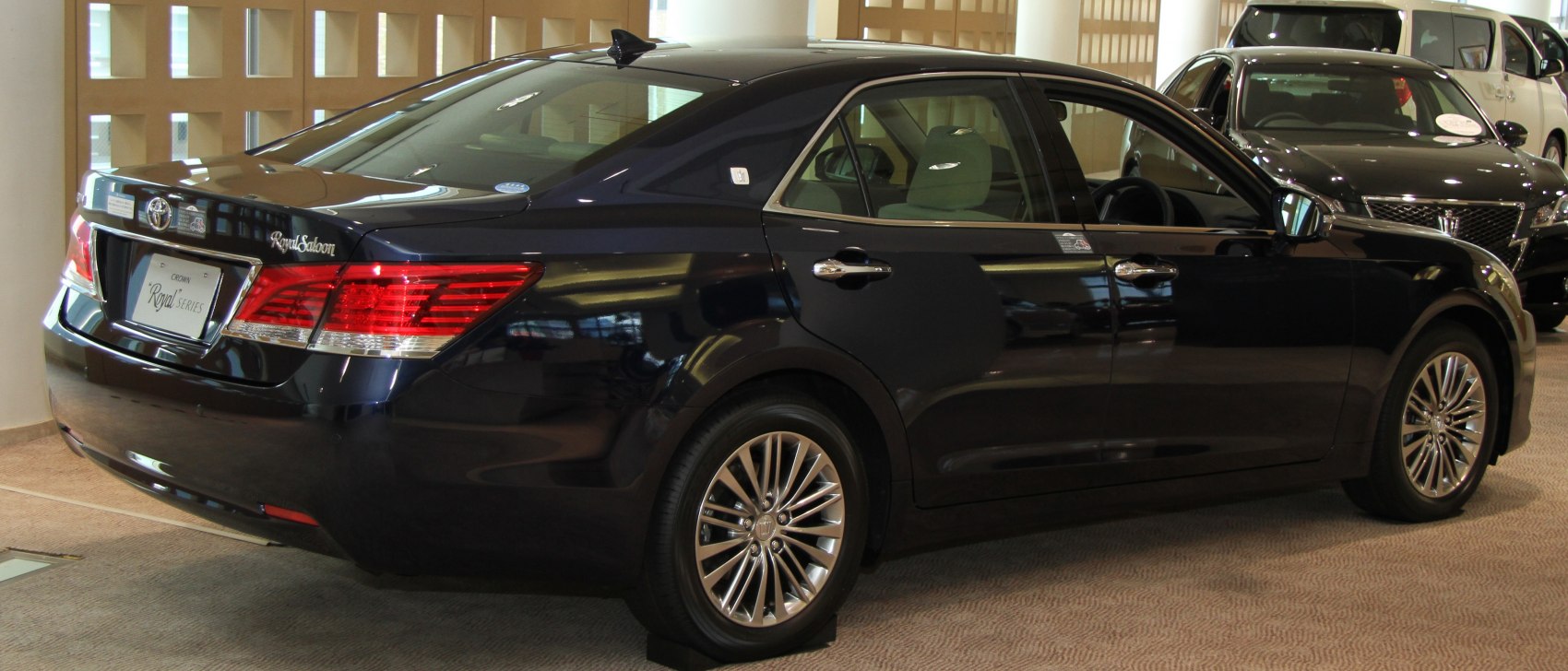 Rear side view of facelifted luxury sedan with multi-spoke alloy wheels
