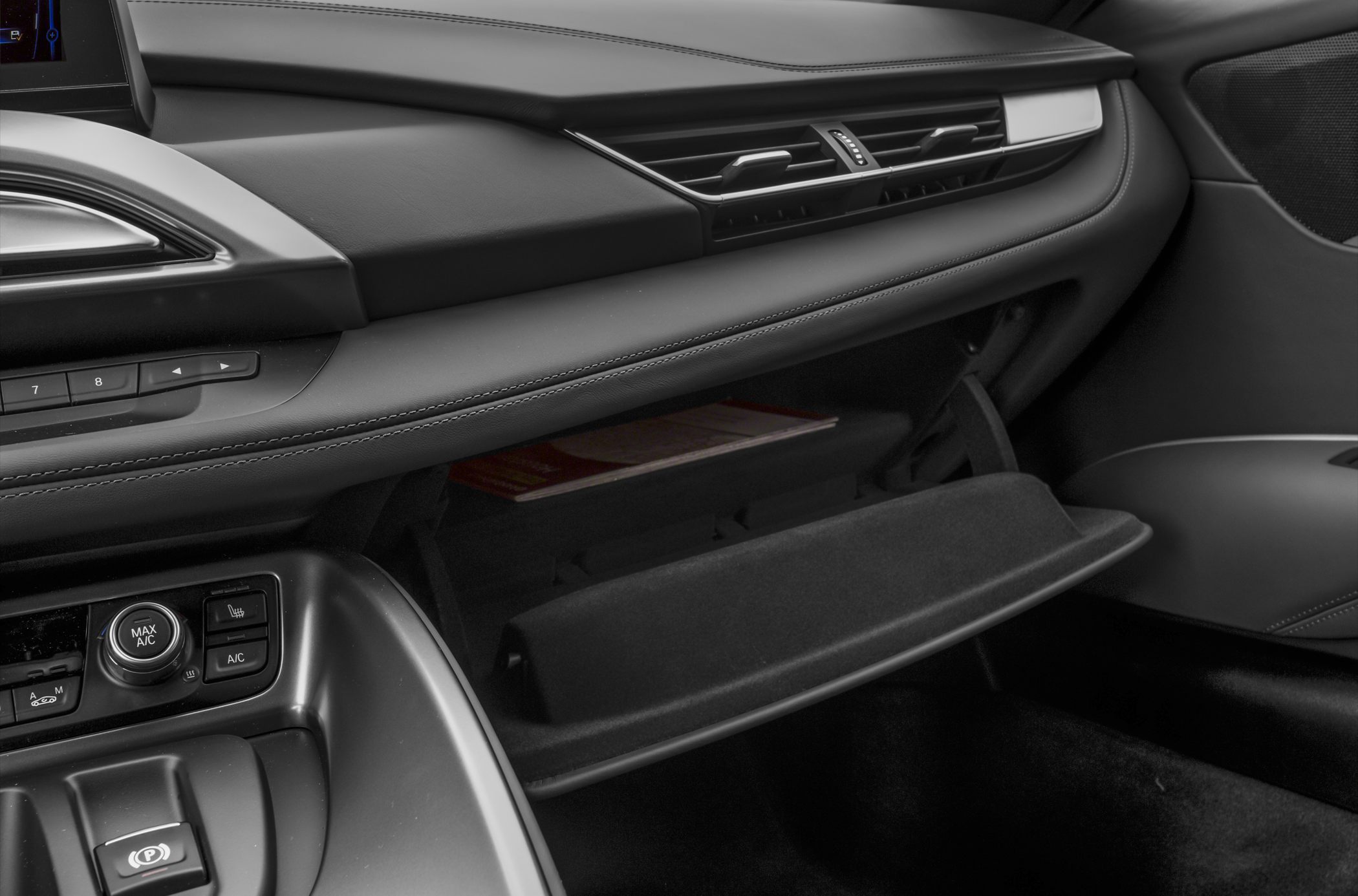 Open glove compartment and dashboard with air vents and controls