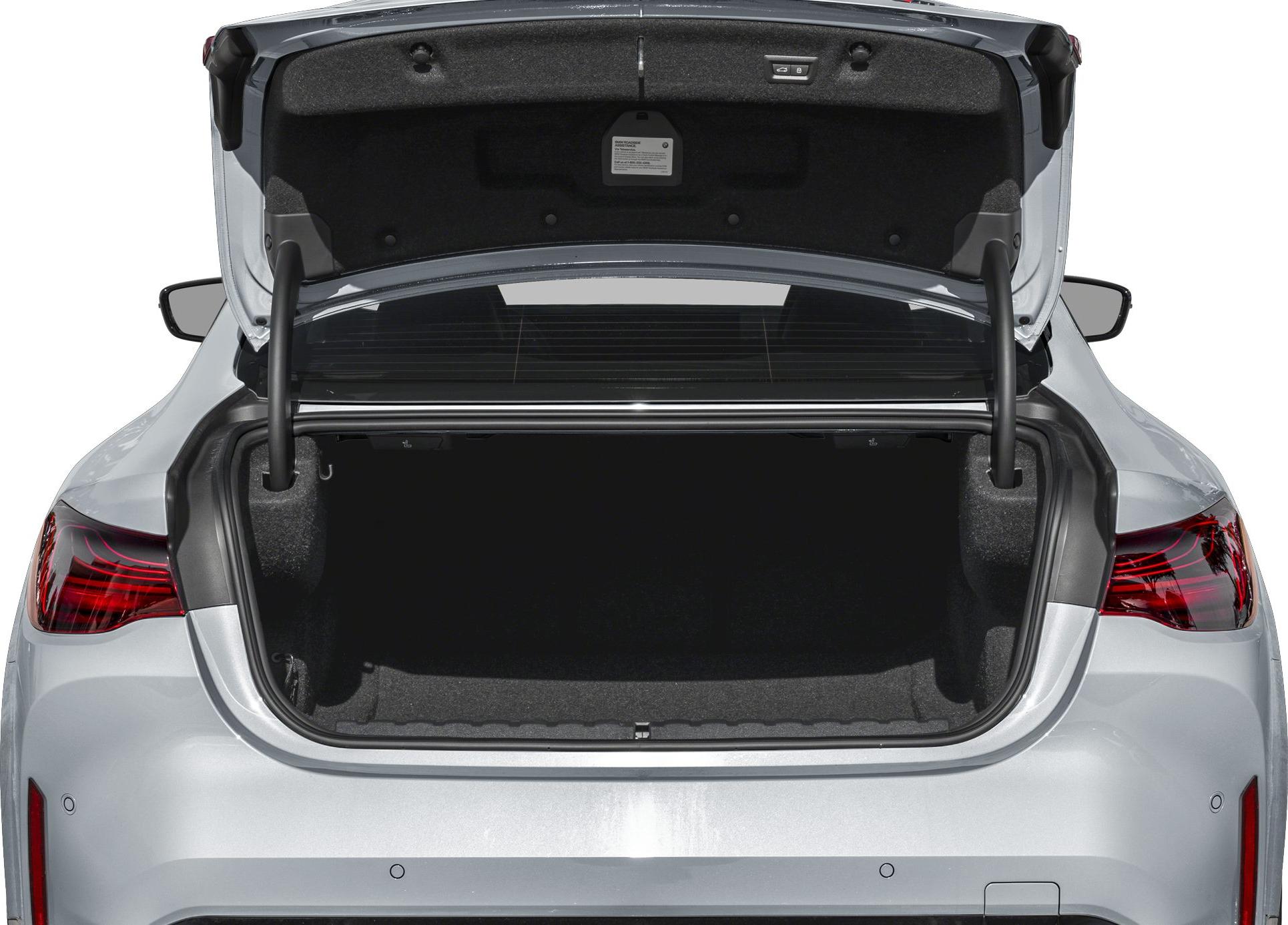 Open trunk cargo space with rear lights and trunk lid hinges