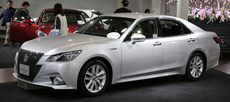 Silver hybrid luxury sedan with alloy wheels and fog lights