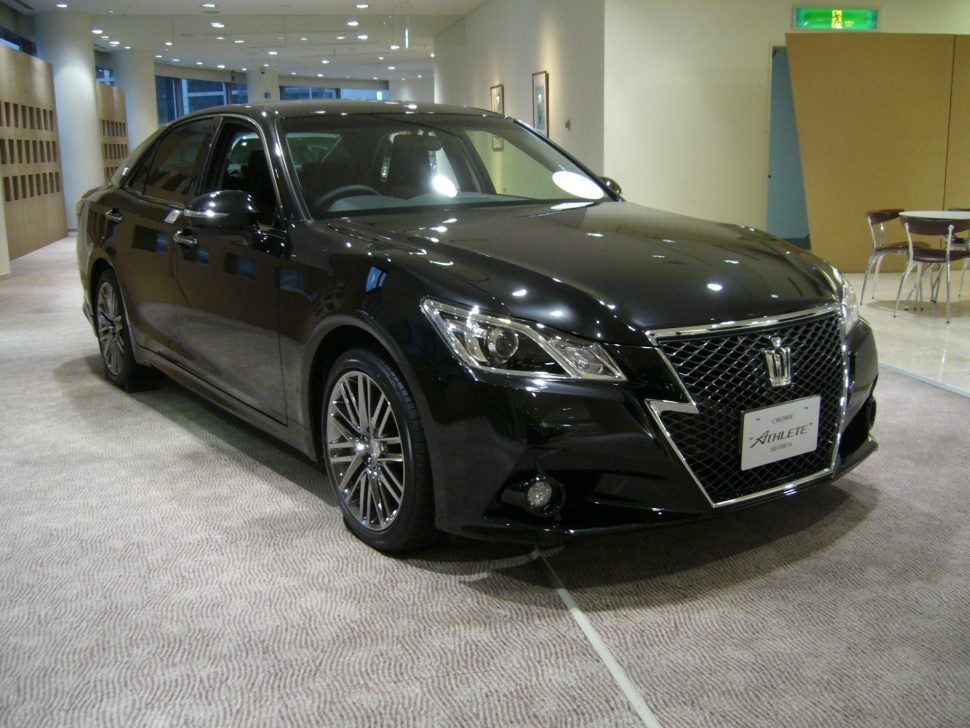 Black luxury sedan with large front grille and sleek aerodynamic design
