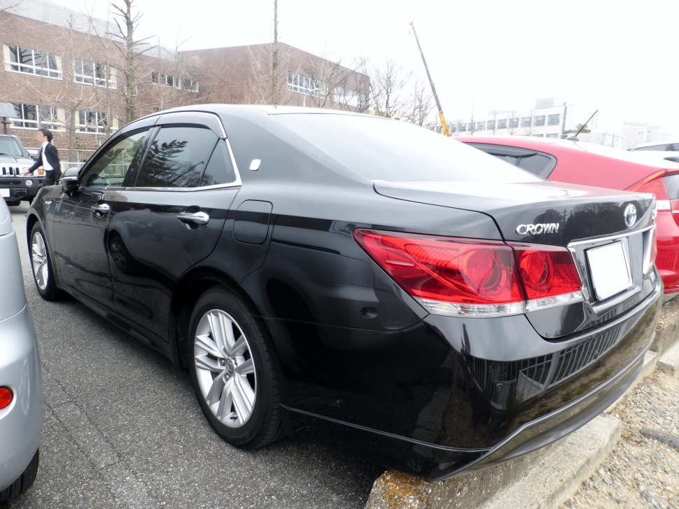Rear side view of a sleek black sedan with distinct taillights and sporty profile