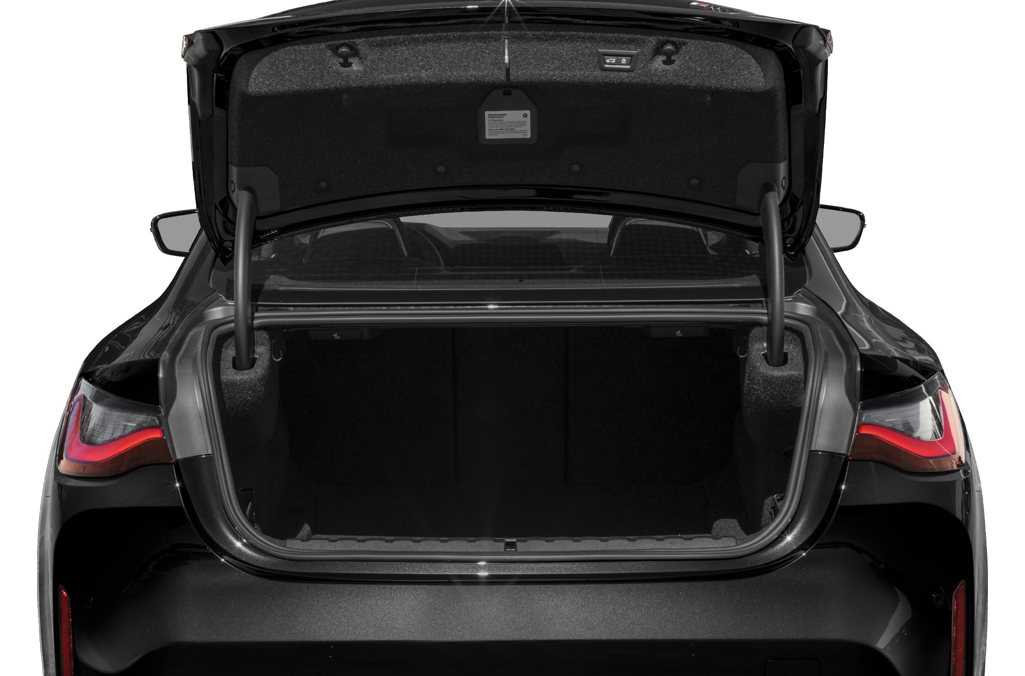 Open trunk space with rear taillights and trunk lid of a sleek coupe
