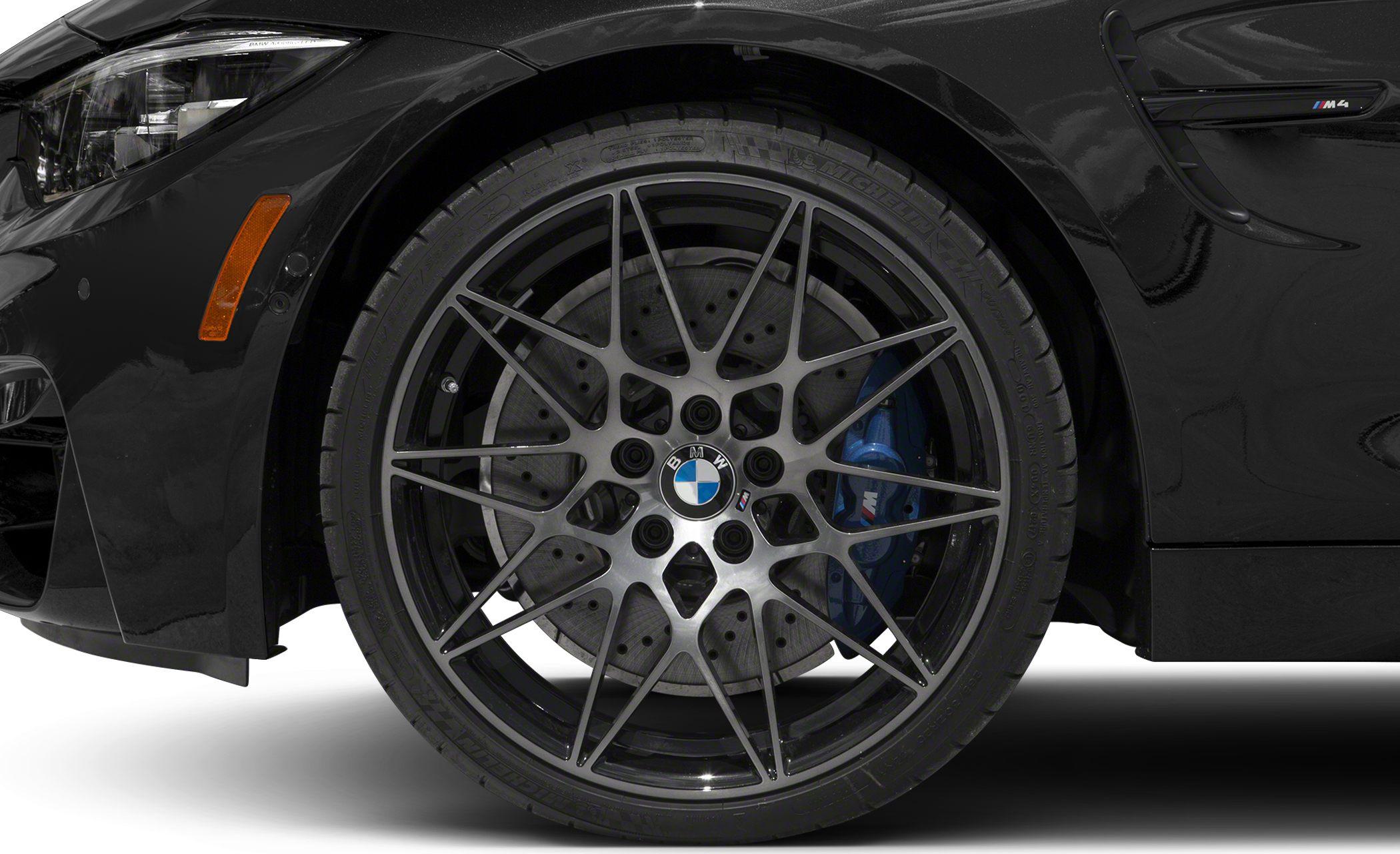 Close-up of multi-spoke wheel with blue brake caliper