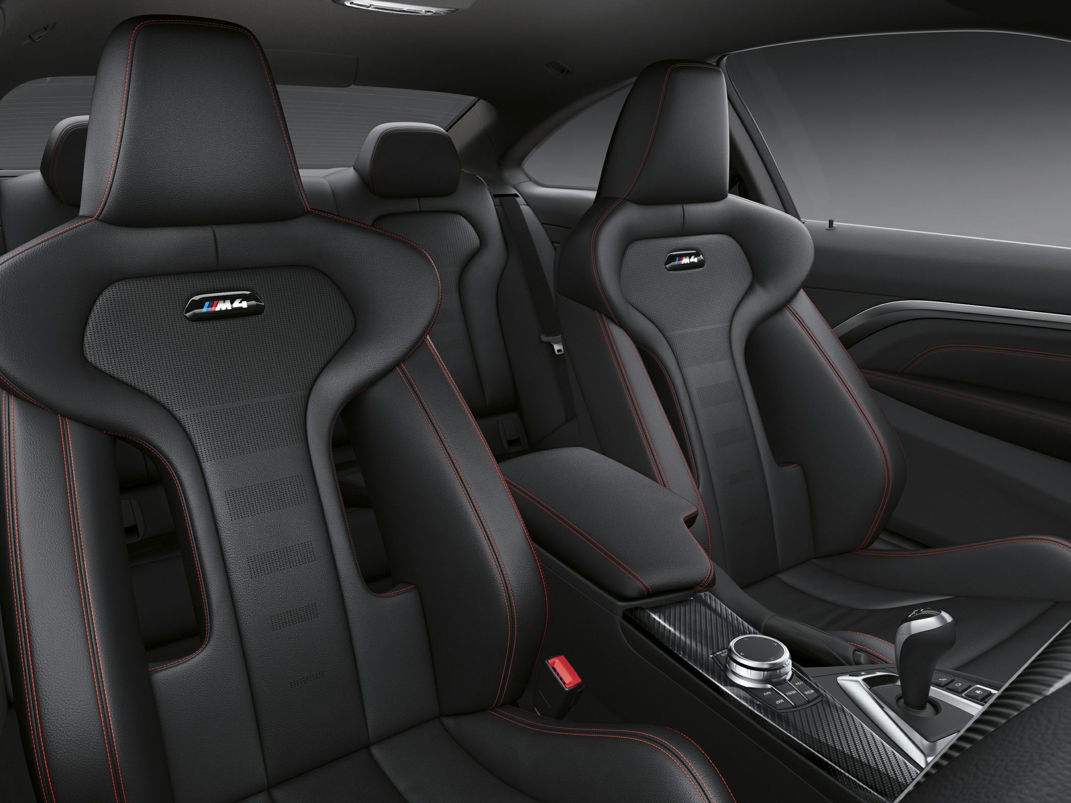 Sporty leather seats with red stitching and carbon fiber center console.