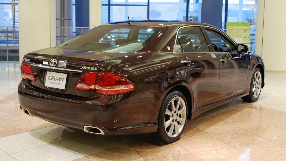 Rear view with taillights and dual exhaust of a luxury sedan.
