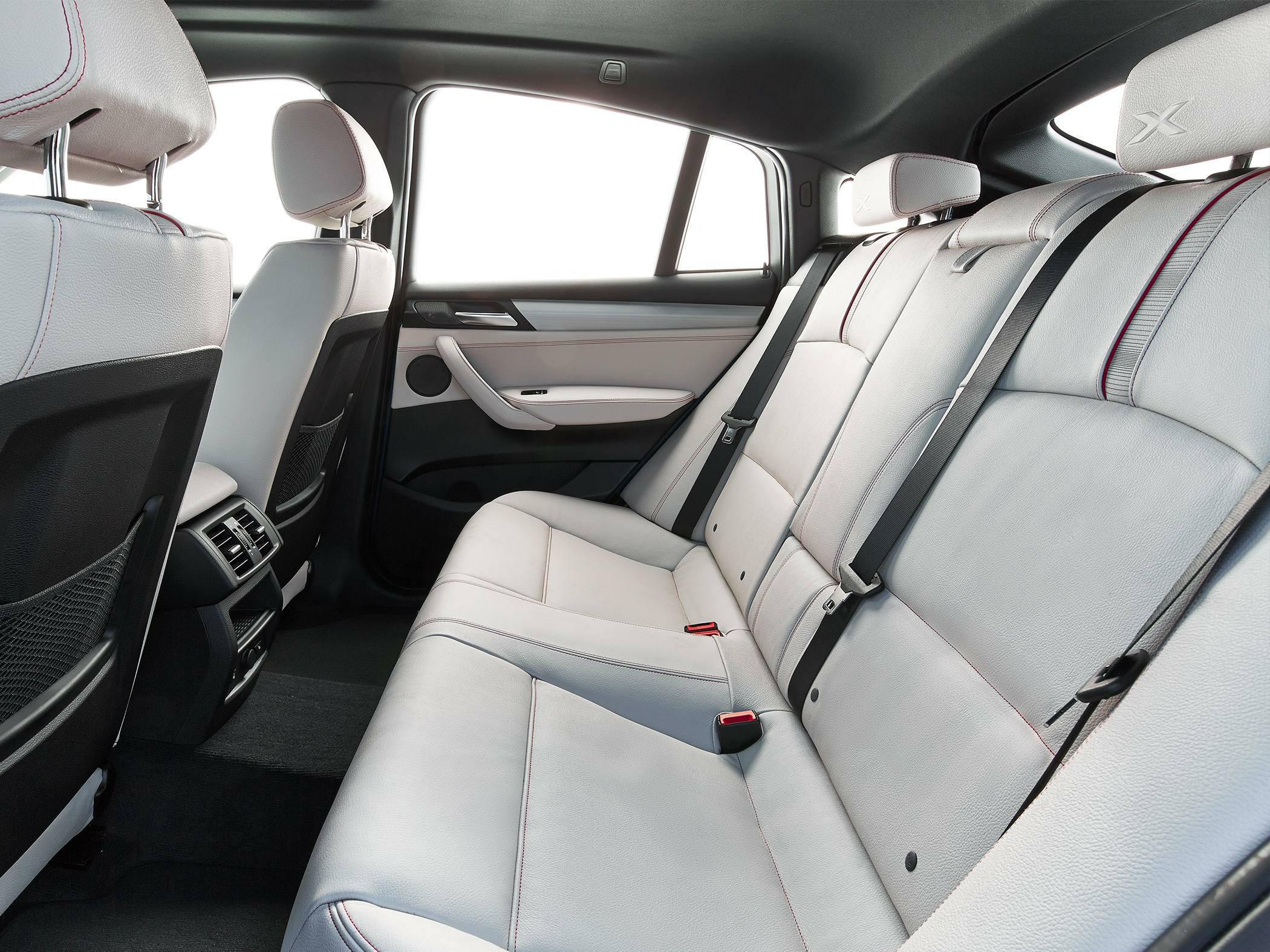 Leather rear seats with integrated headrests and red stitching