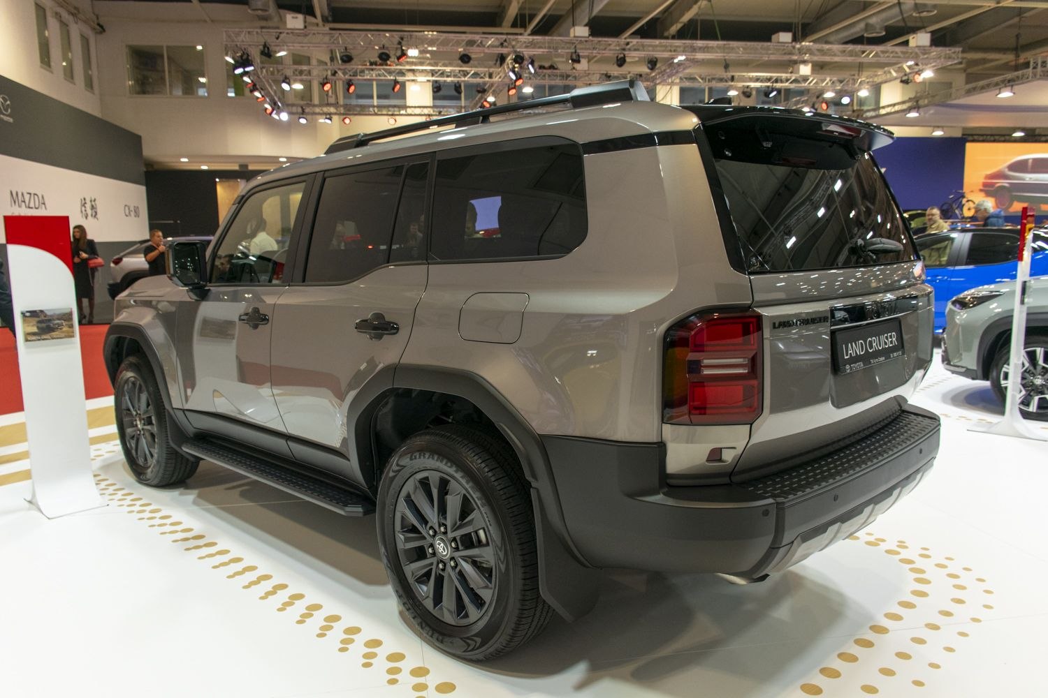 SUV rear profile with black alloy wheels and roof rails