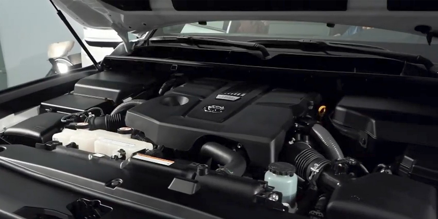 Close-up of engine compartment with prominent engine cover and mechanical components