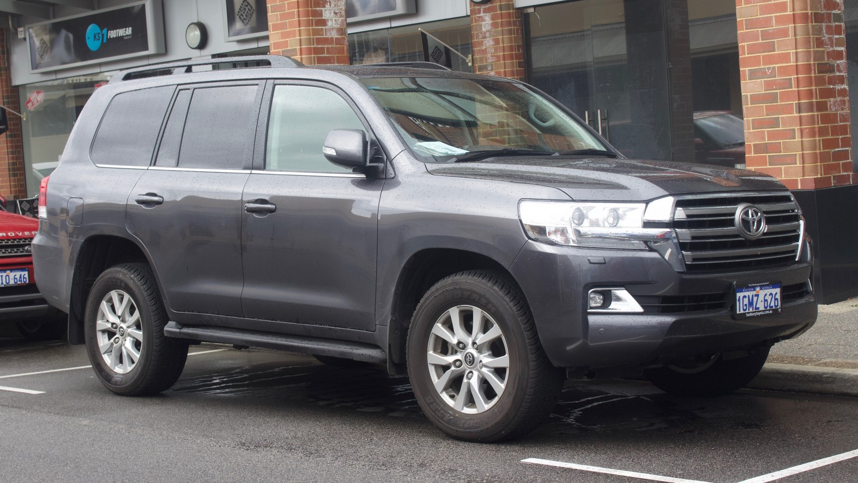 Front side view of SUV with alloy wheels and modern headlights