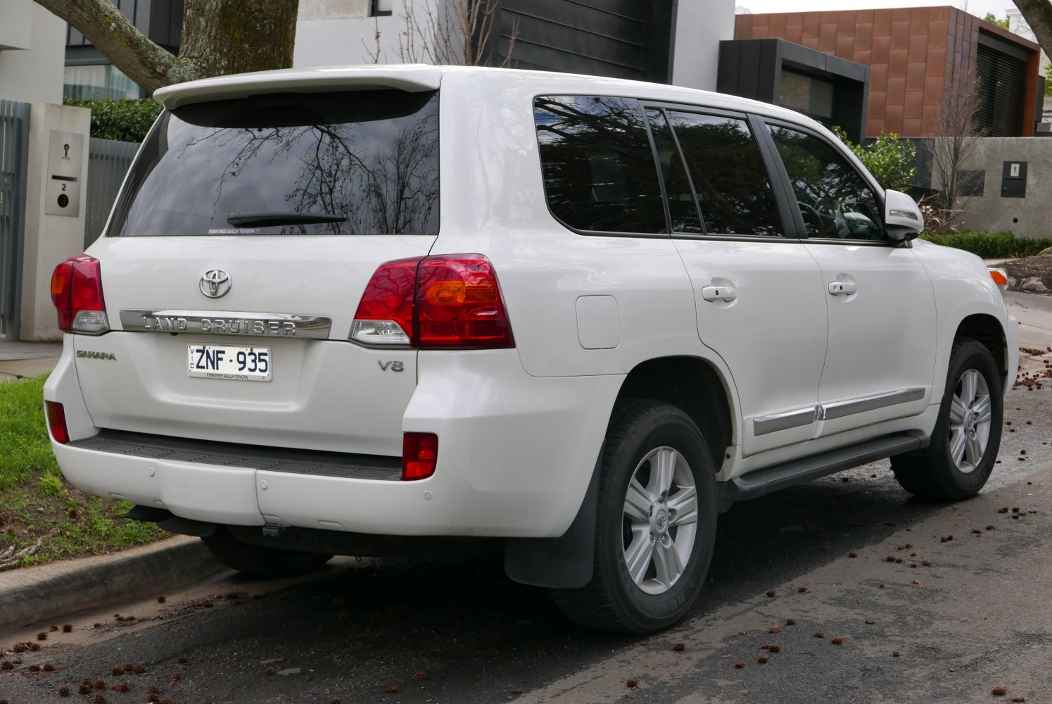 Rear view of a large SUV with V8 badge and tinted windows
