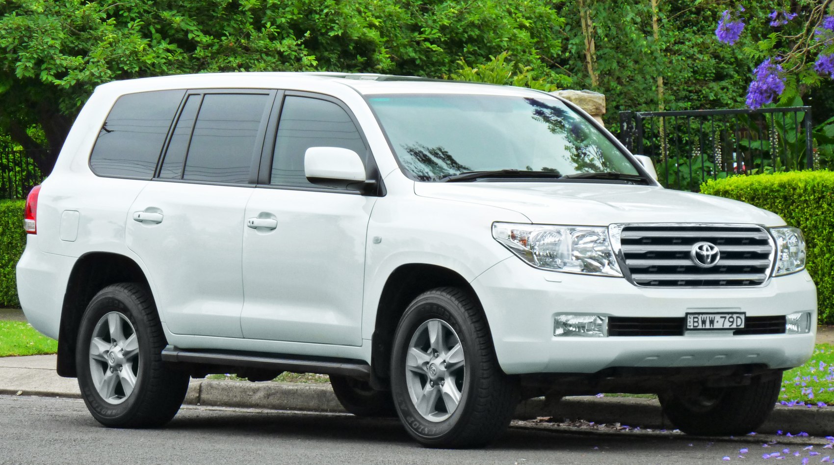 White SUV with prominent front grille and alloy wheels