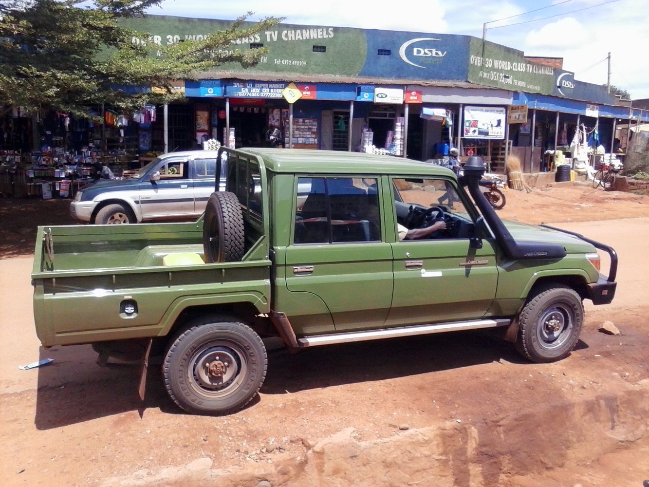 Side view of rugged pickup with snorkel and double cab