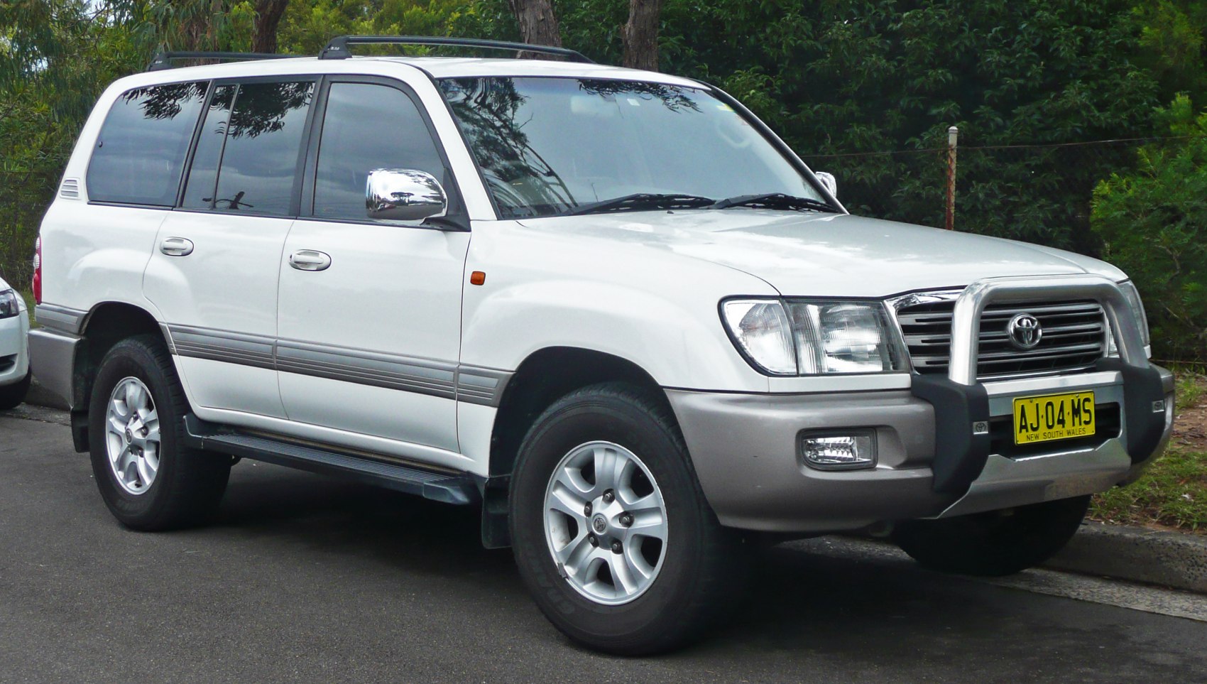 White SUV with bullbar and alloy wheels, front-side perspective
