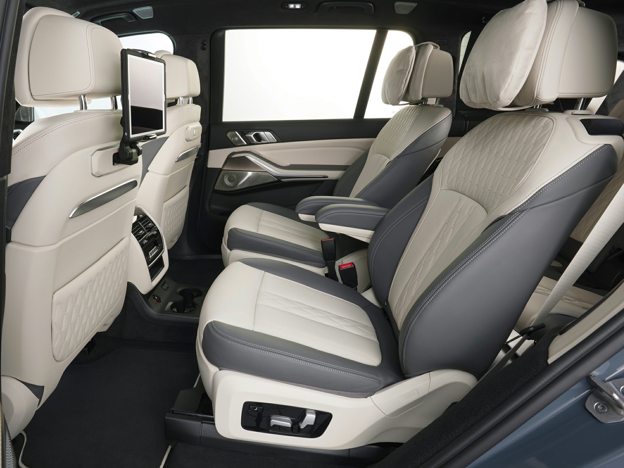 Rear passenger seats with leather upholstery and integrated entertainment screens.