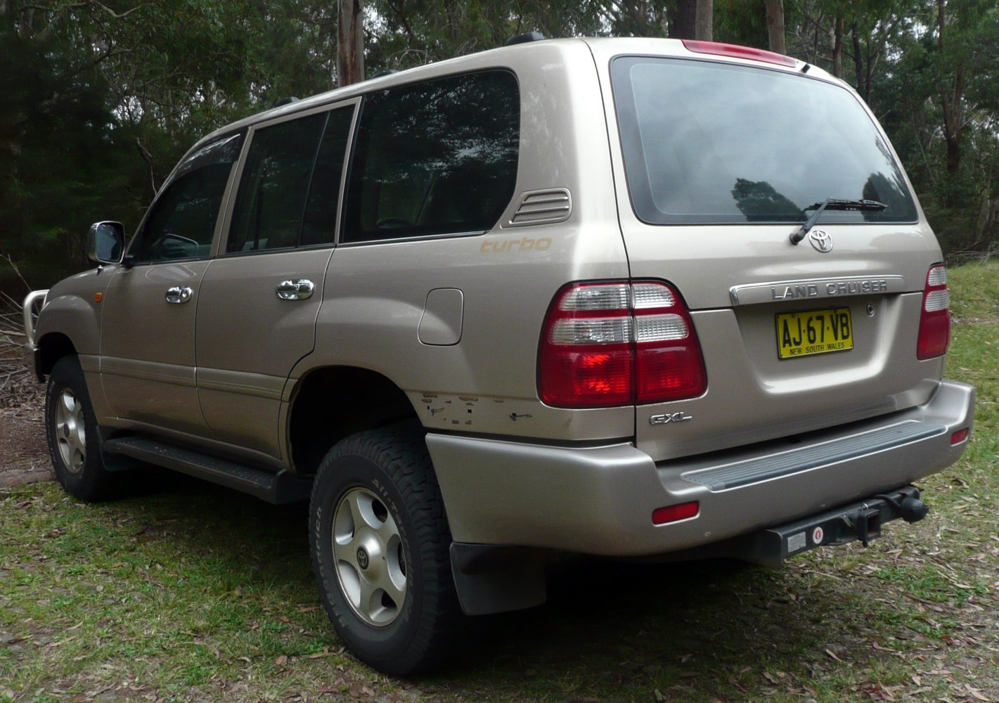 Rear and side view of SUV with tinted windows and taillights