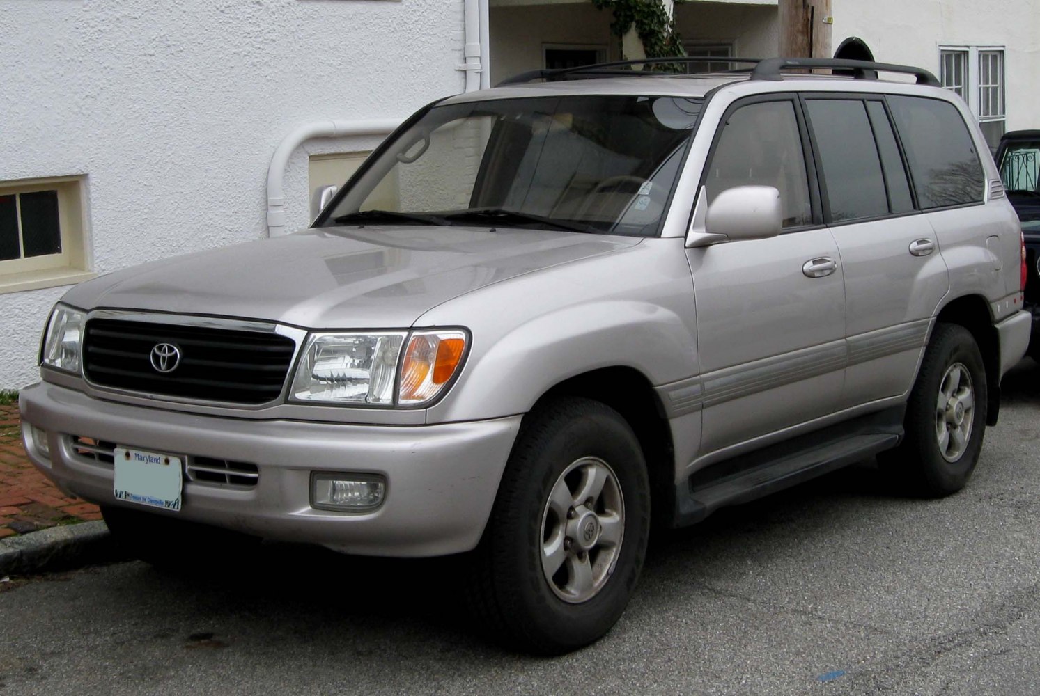 Front-side view of a silver SUV with roof rails and alloy wheels