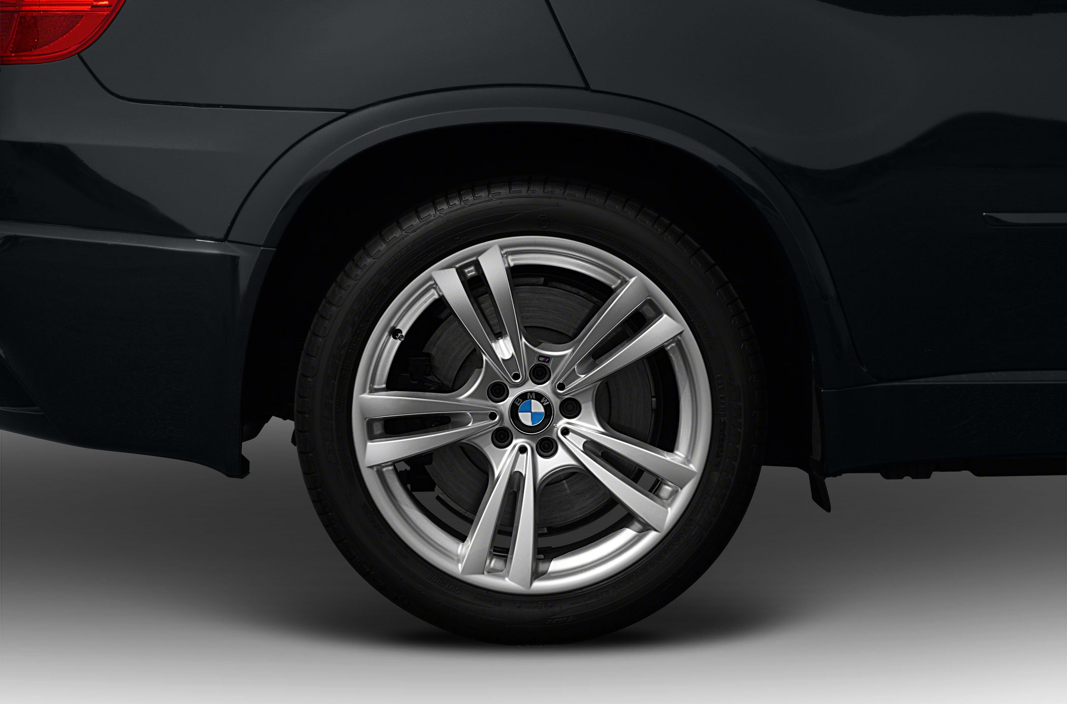 Alloy wheel and tire close-up with brake disc behind