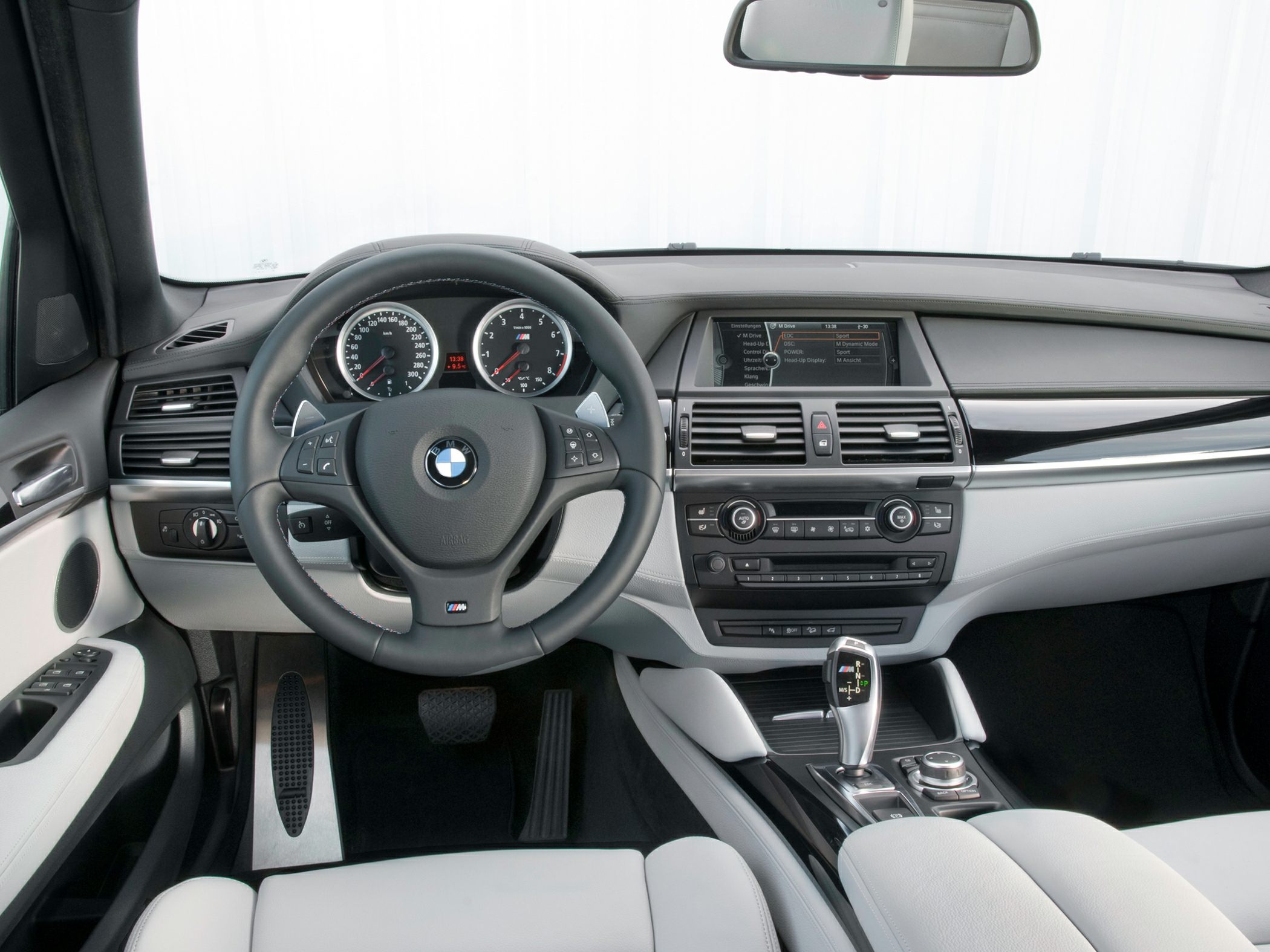 Sporty steering wheel and instrument cluster with central infotainment