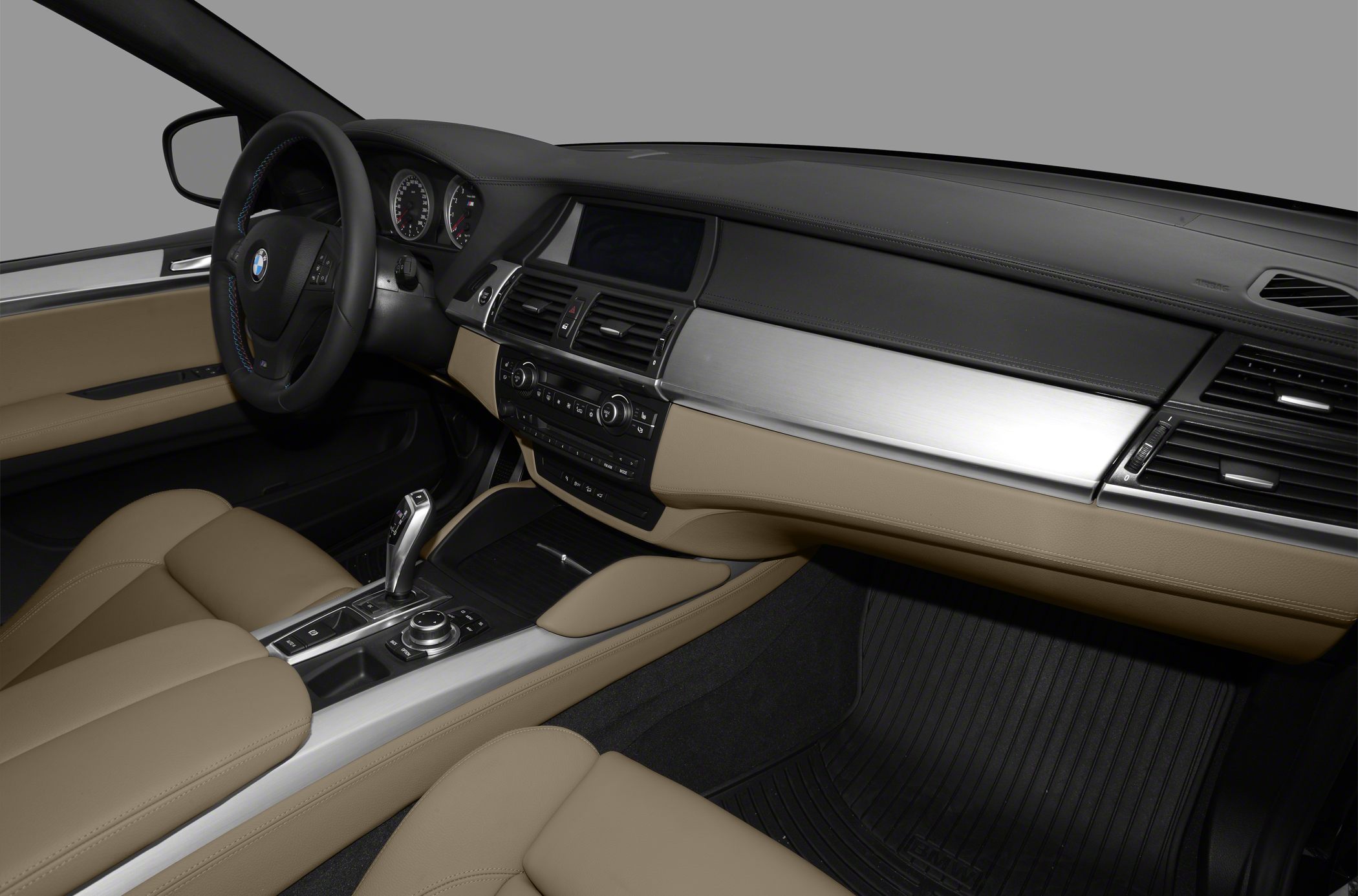 Beige leather interior with advanced dashboard and automatic gear shifter.