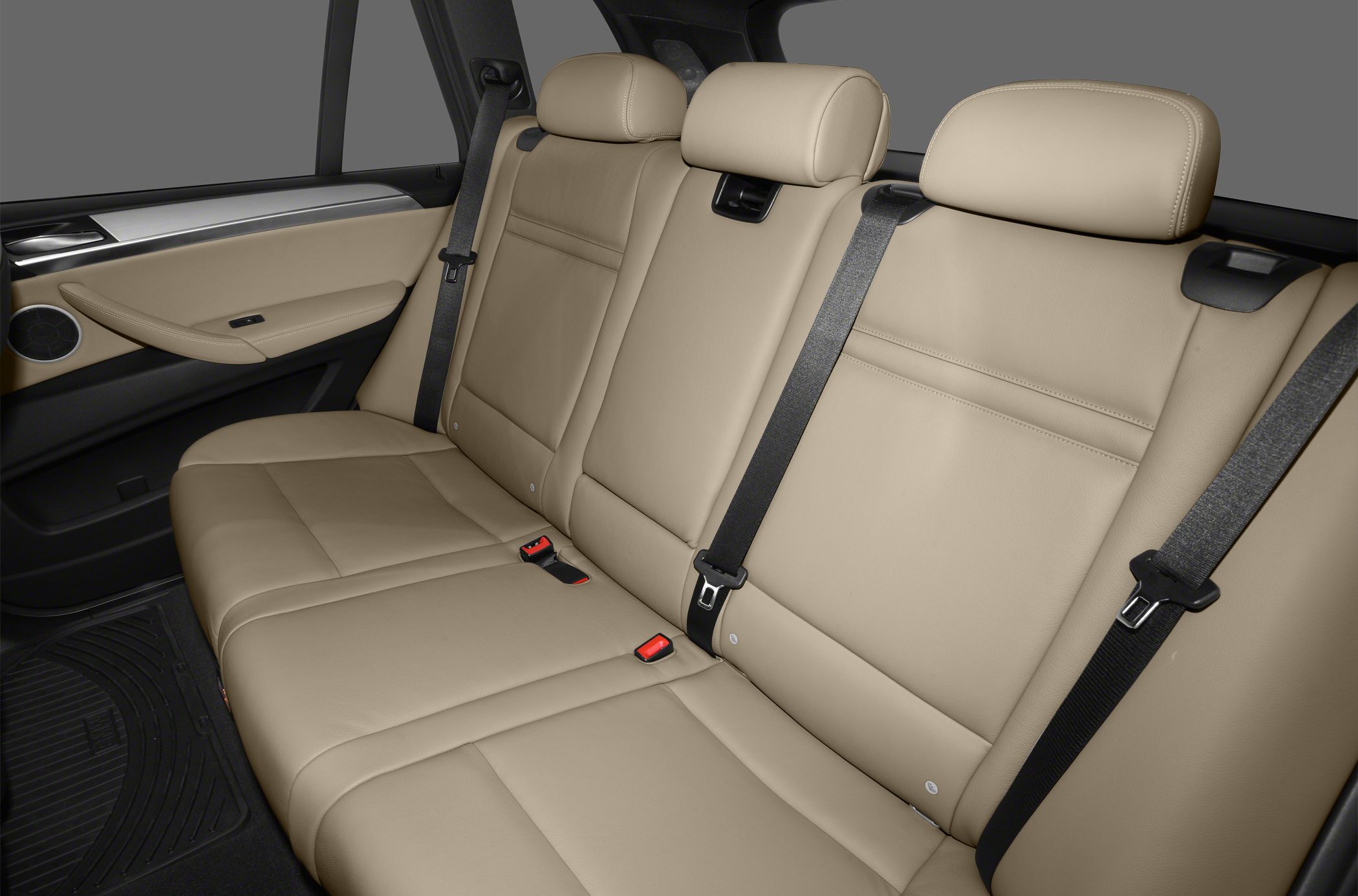 Beige leather rear seats with seatbelts and headrests
