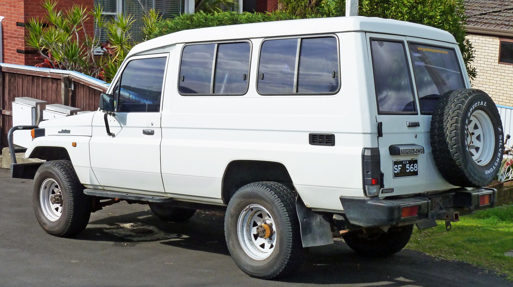 Long wheelbase SUV with rear spare tire and rugged 4WD design