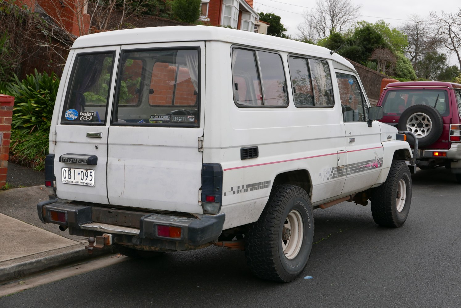 Rear and side view of an SUV with off-road tires and boxy design