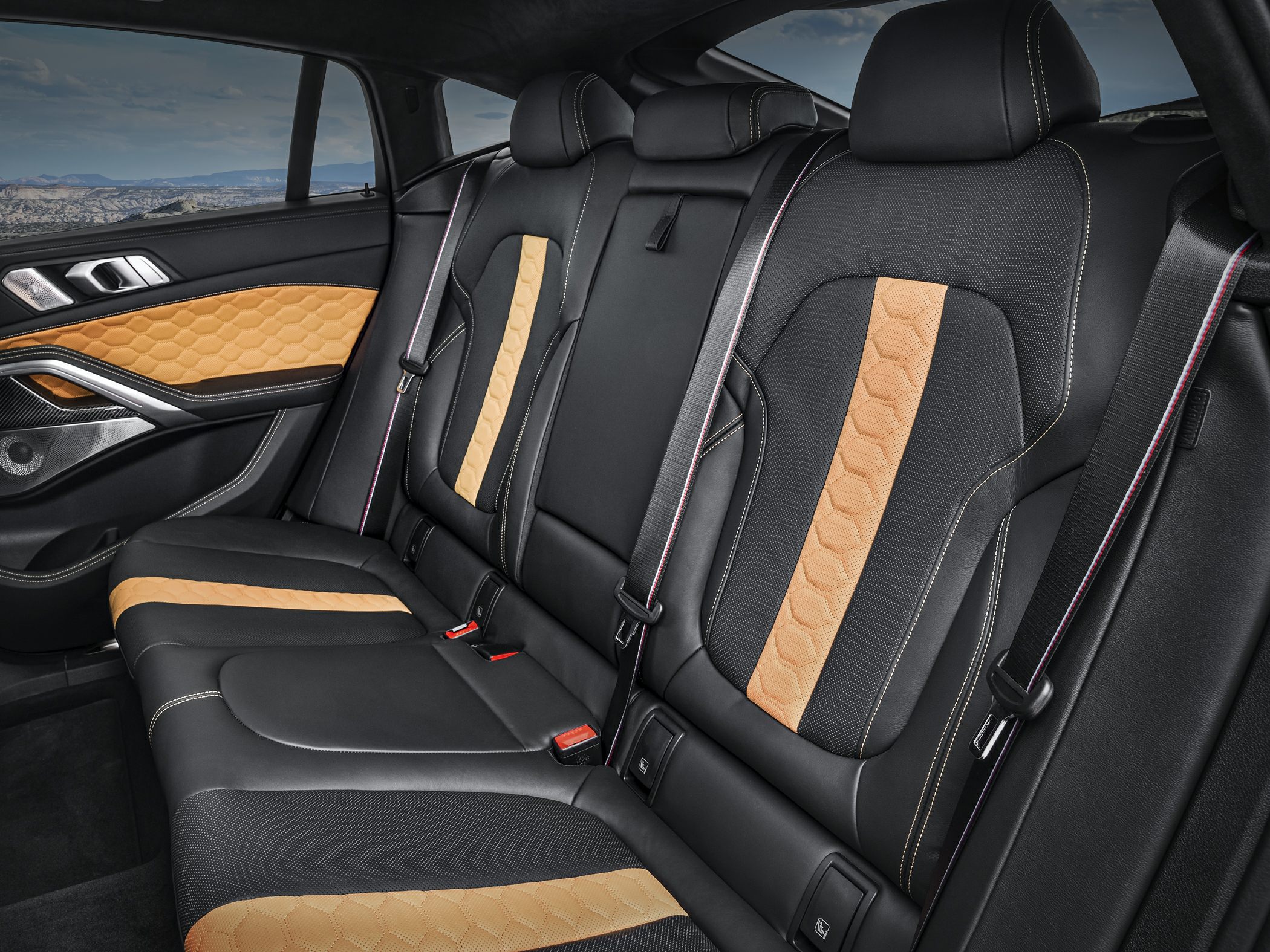 Black and tan quilted leather rear seats with detailed stitching