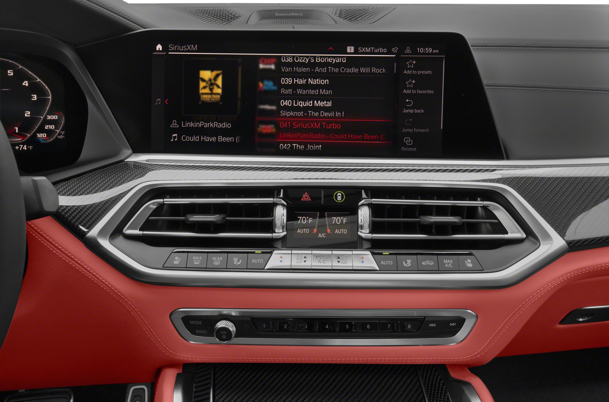Digital infotainment screen with climate control and red leather interior trim.
