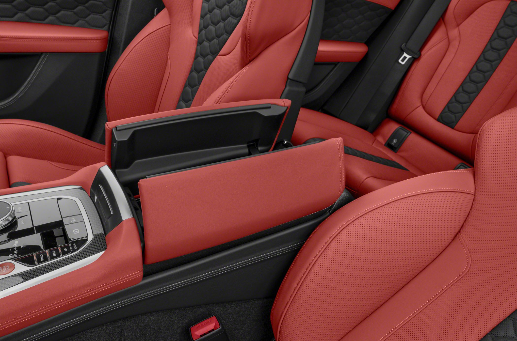 Red leather seats and open central console storage with control panel.