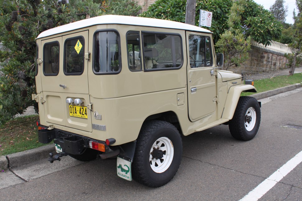 Rear-side view of vintage off-road SUV with hard top and rugged tires