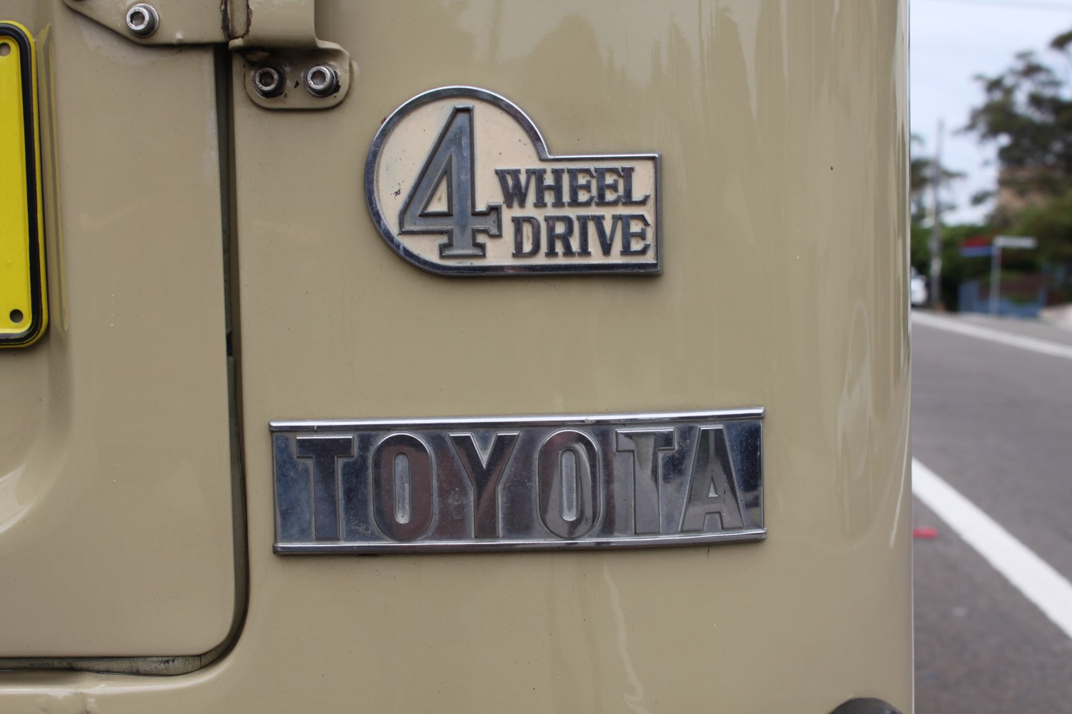 Close-up of vintage 4 Wheel Drive emblem and Toyota badge on SUV rear