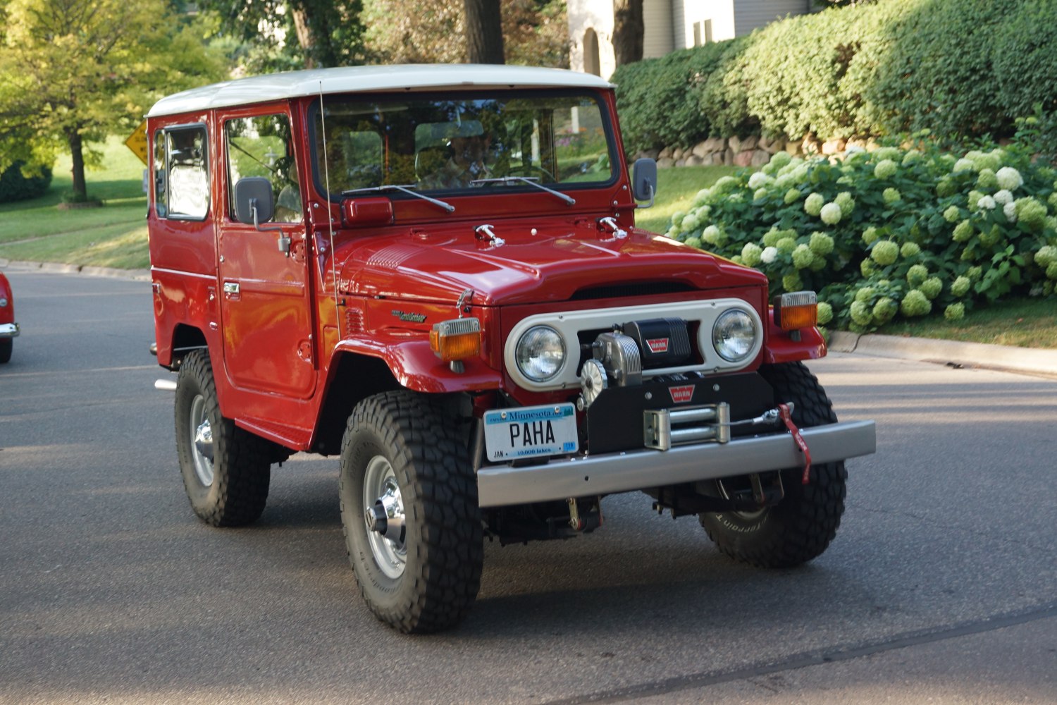 Red vintage off-road vehicle with front winch and rugged tires