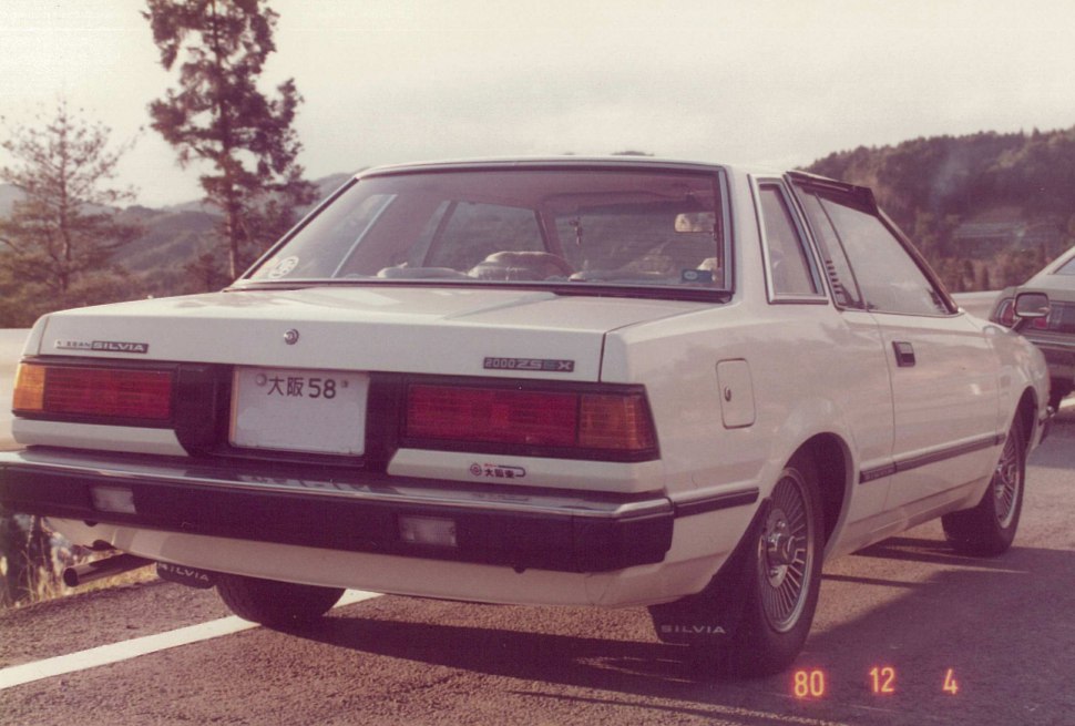 Rear view of a vintage 1980s coupe with classic tail lamps and styling