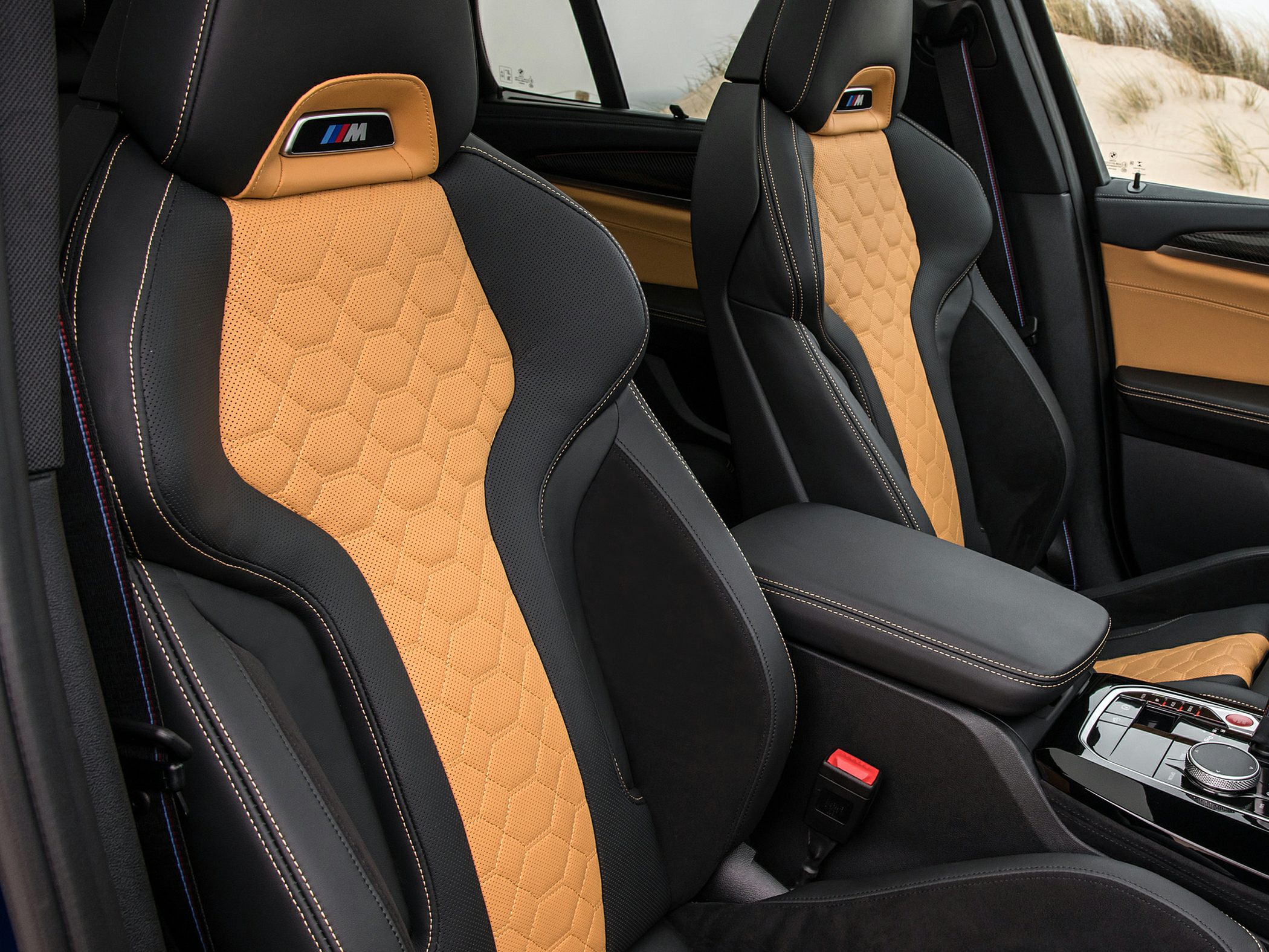 Two-tone perforated leather sports seats with M logo and hexagonal stitching