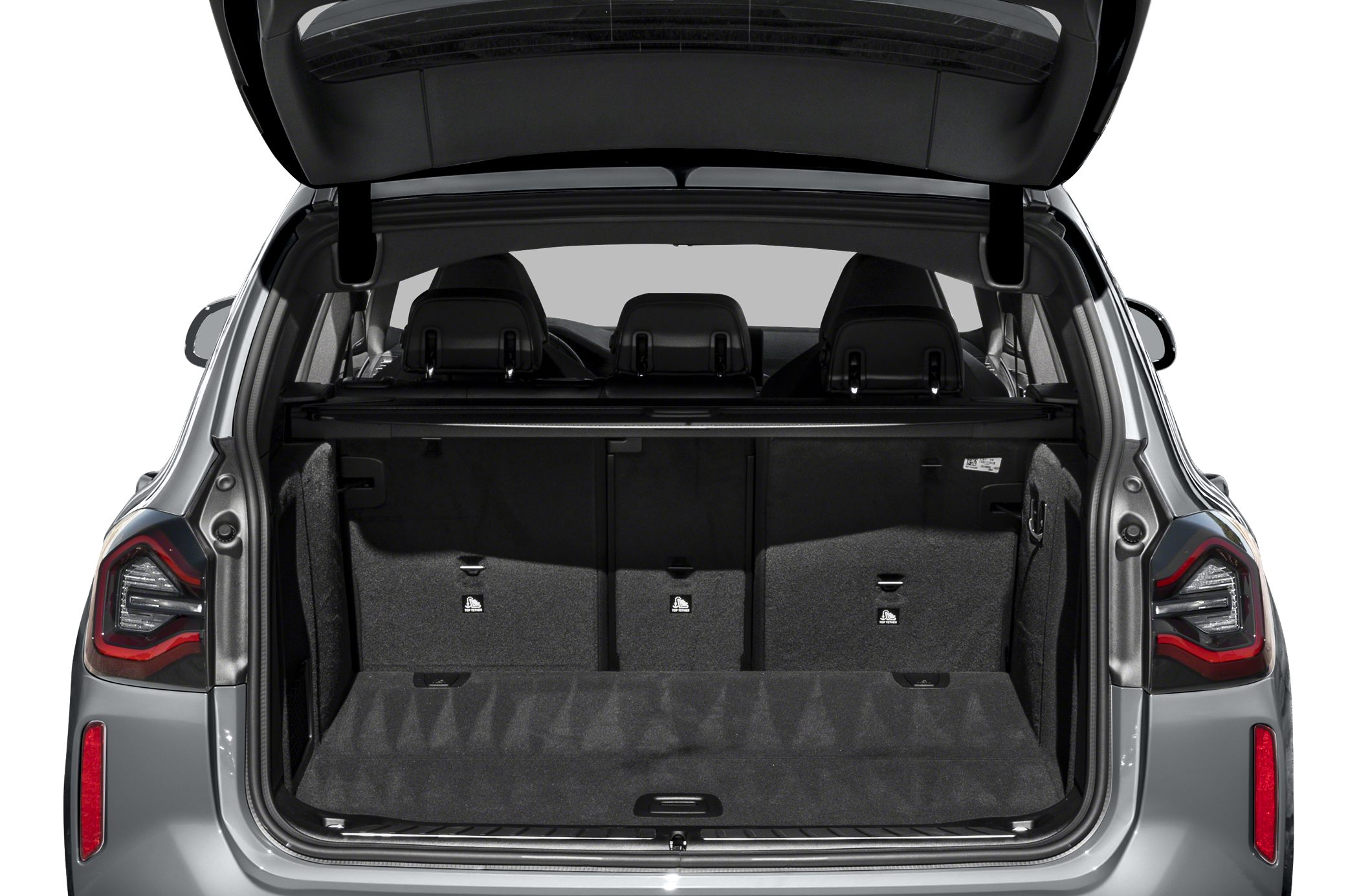 Open trunk cargo space with foldable rear seats and black upholstery.