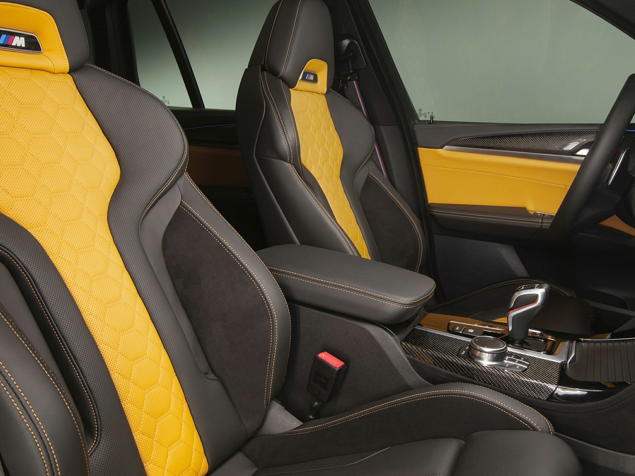 Yellow hexagonal-stitch seats with carbon fiber trim and M badge