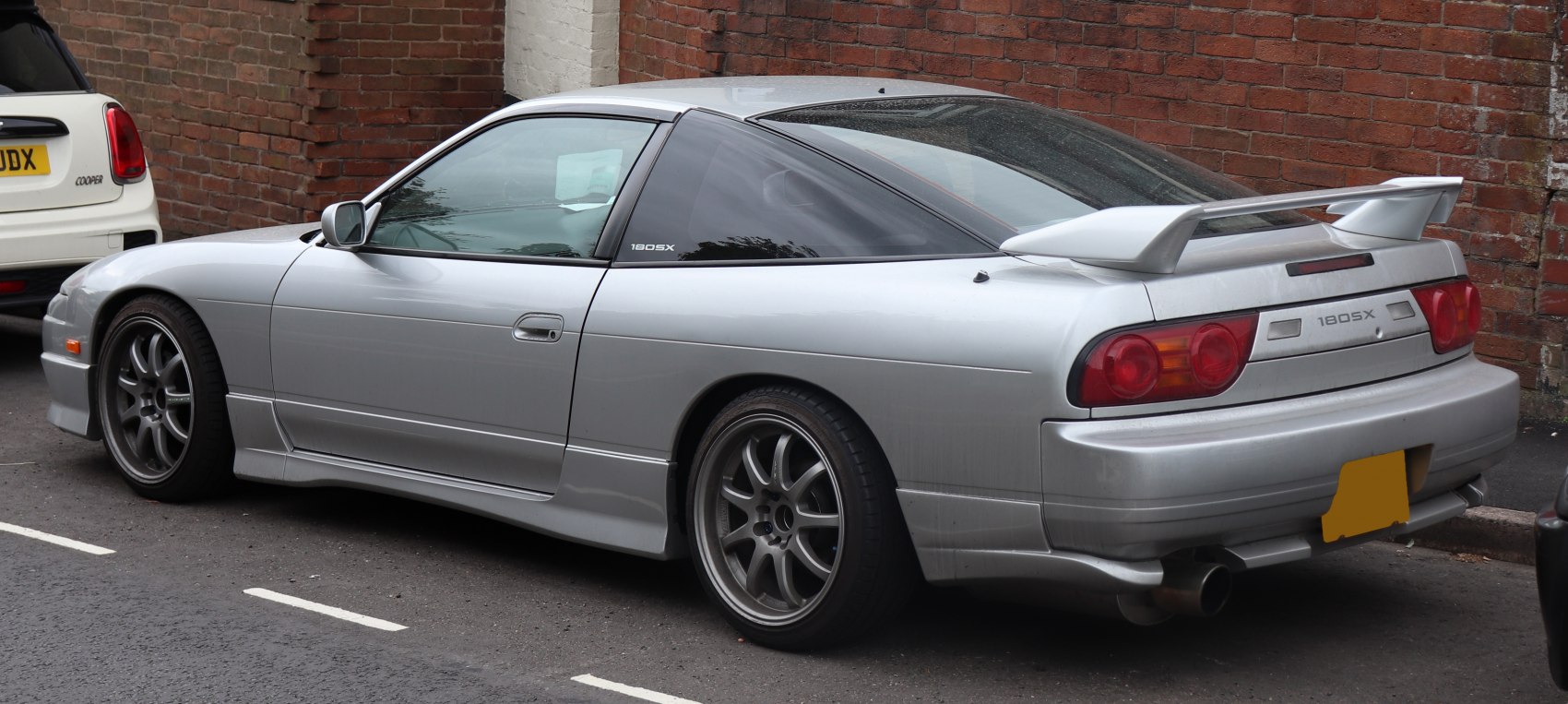 Silver sports coupe with rear spoiler and alloy wheels