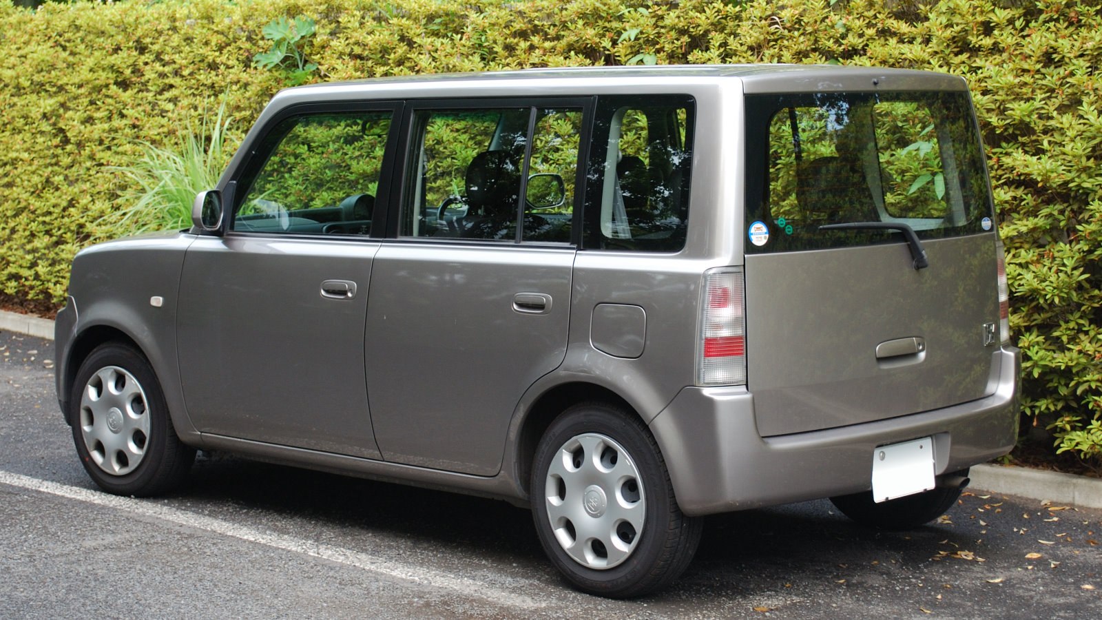 Boxy compact hatchback with rounded wheel covers and flat rear hatch.