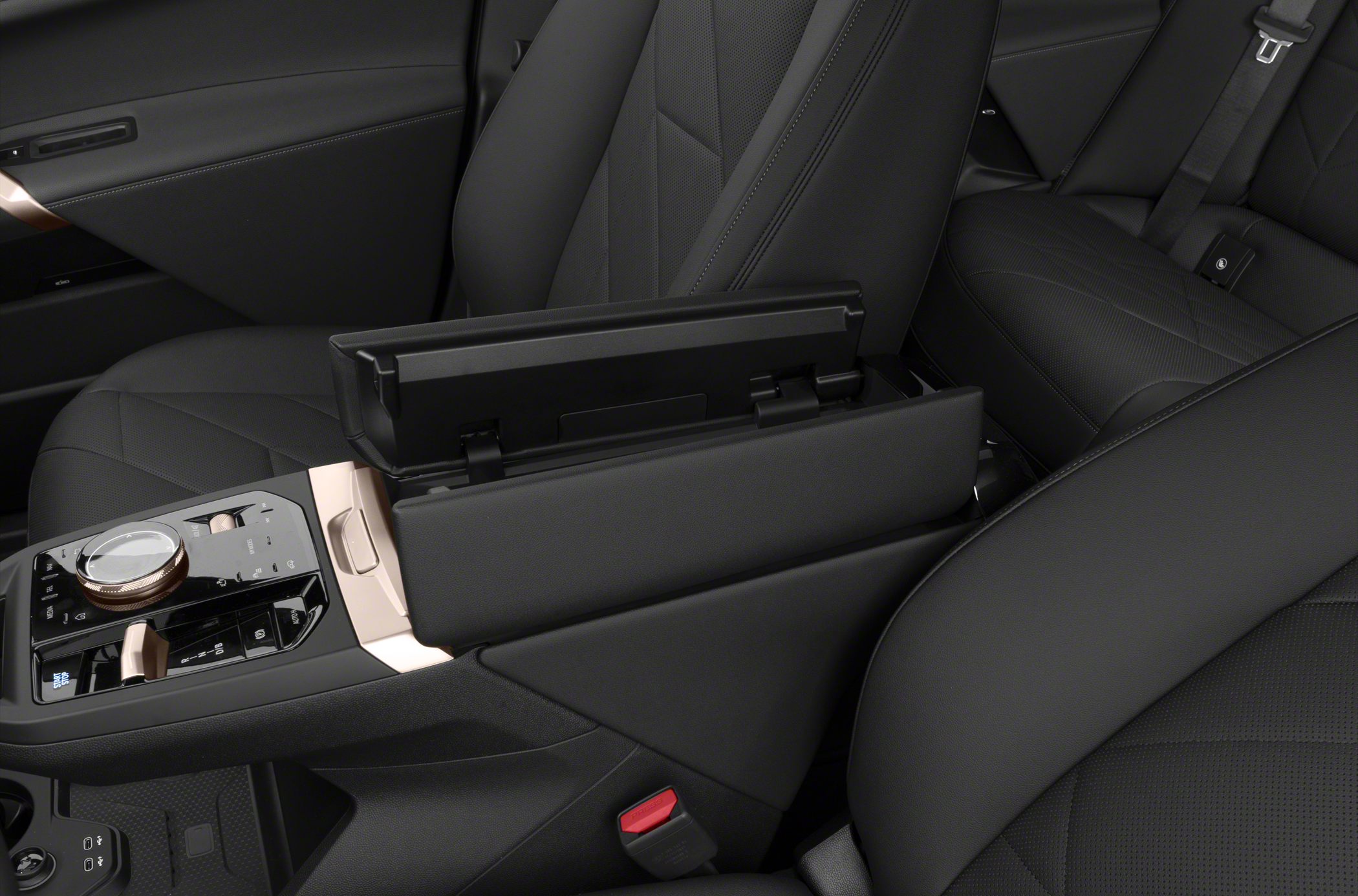 Center console controls and open armrest storage in luxury vehicle interior