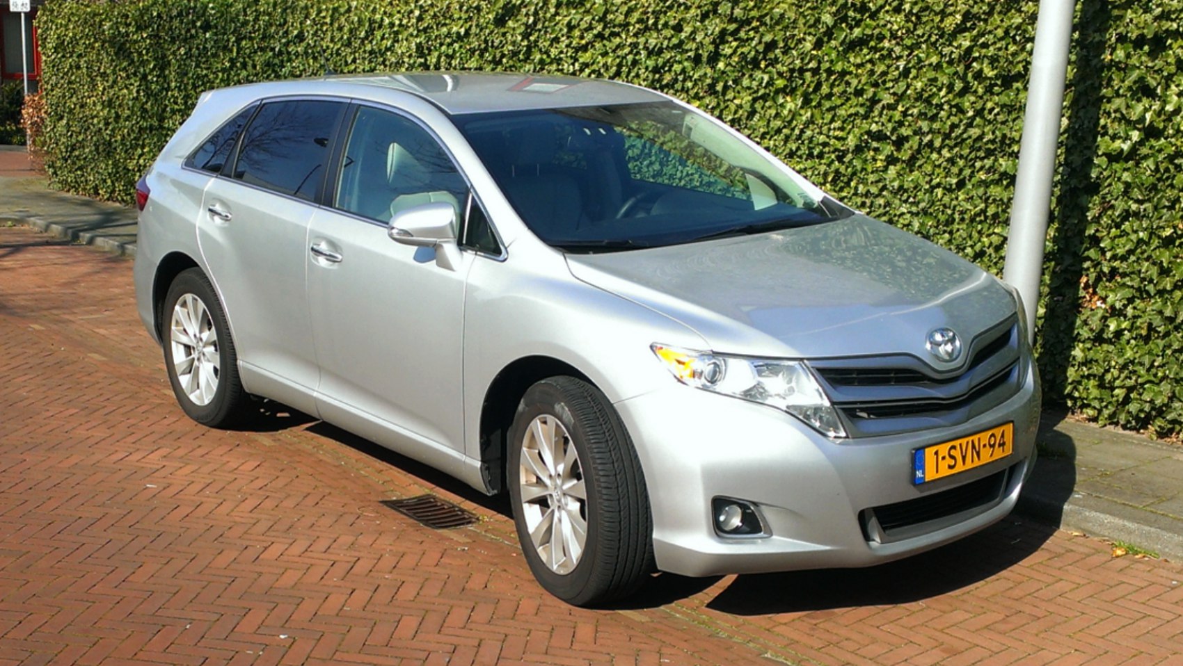 Silver mid-size crossover in front-side view with alloy wheels and sleek headlights